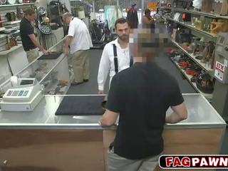 Dude blows a cock behind counter in a shop